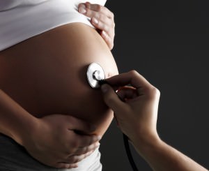 An isolated shot of a pregnant woman being examined by a doctor