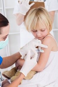 brave little girl getting injection at doctors office