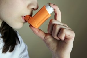 Girl breathing asthmatic inhaler