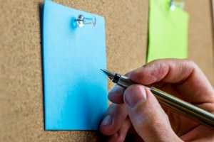 Writing on blue post it paper