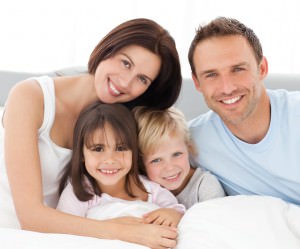 Lovely family sitting together on the bed